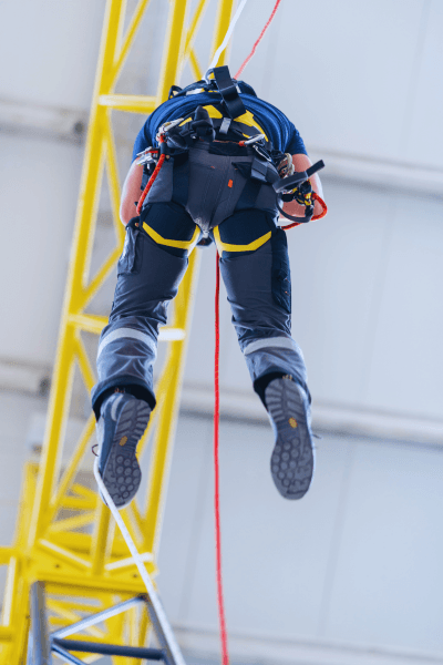 Trained field worker using safety equipment while working at height